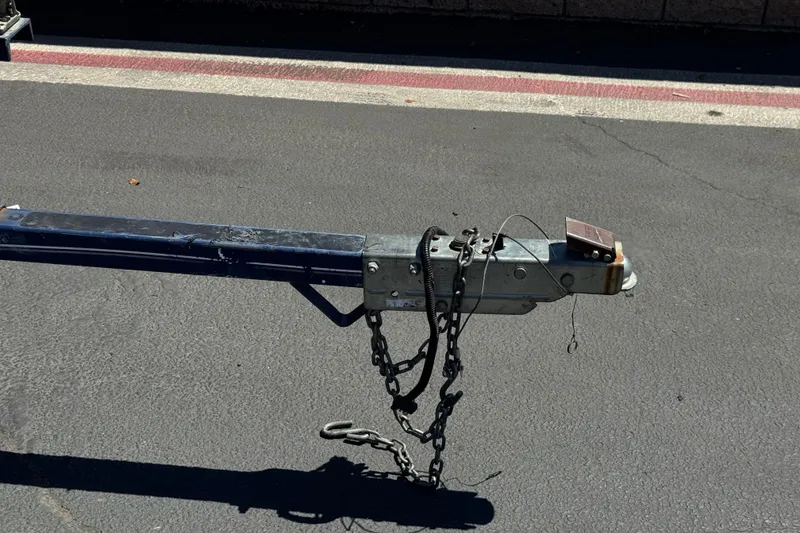 Slide: The Image of Trailer hitch of a 2001 Four Winns 180 Horizon boat on asphalt. - 24