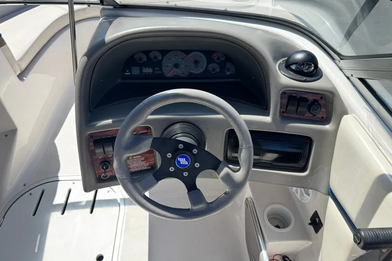 Slide: The Image of 2001 Four Winns 180 Horizon boat dashboard with steering wheel and instrument panel. - 19