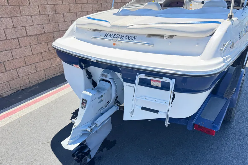 Slide: The Image of 2001 Four Winns 180 Horizon boat rear view with outboard motor and ladder. - 6
