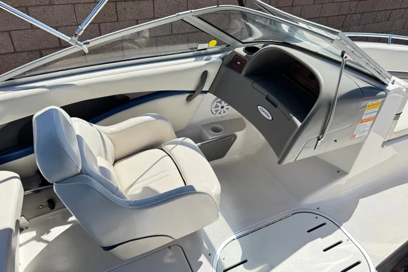 Slide: The Image of 2001 Four Winns 180 Horizon boat interior with white seating and dashboard. - 16