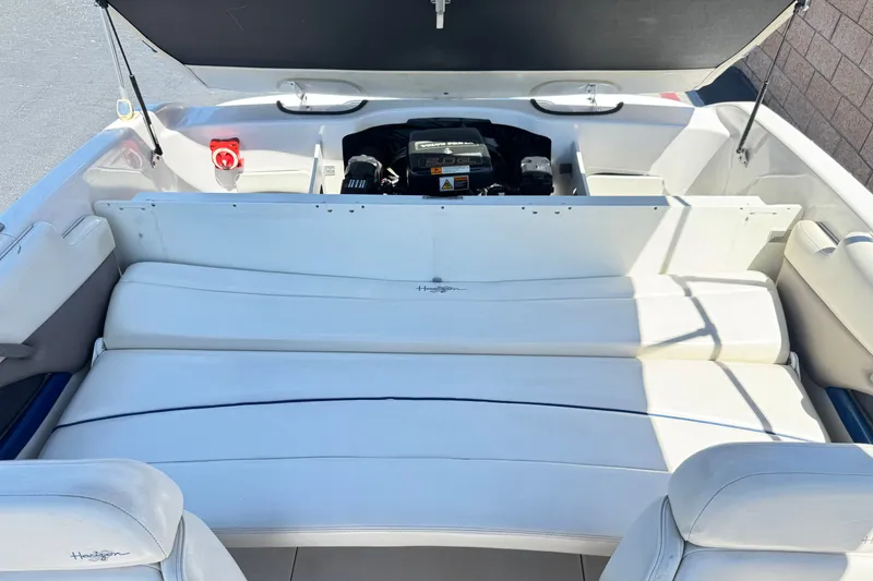 Slide: The Image of 2001 Four Winns 180 Horizon boat interior with open engine compartment and white seating. - 13
