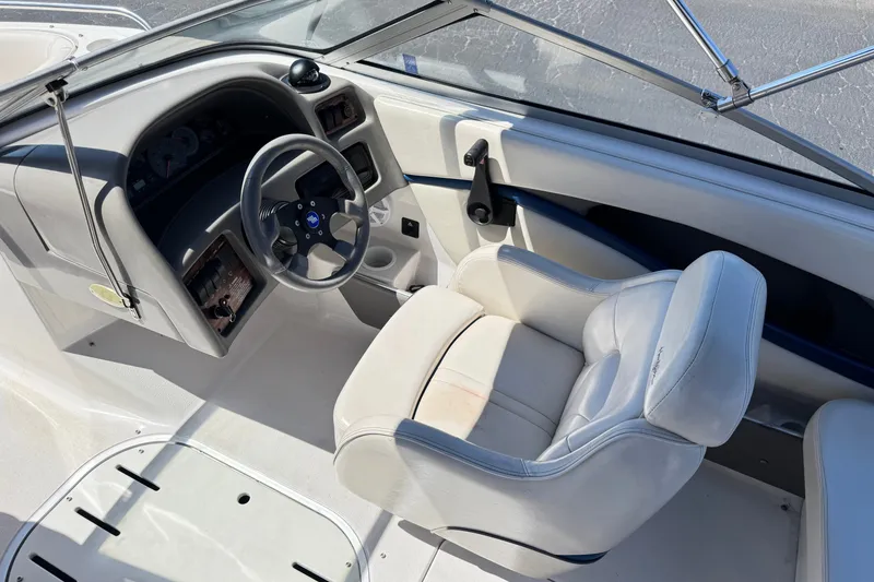 Slide: The Image of Interior of a 2001 Four Winns 180 Horizon boat, featuring steering wheel and captain's seat. - 18