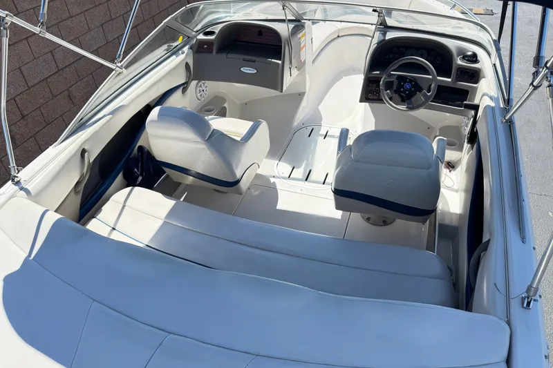 Slide: The Image of 2001 Four Winns 180 Horizon boat interior with white seating and steering console. - 8