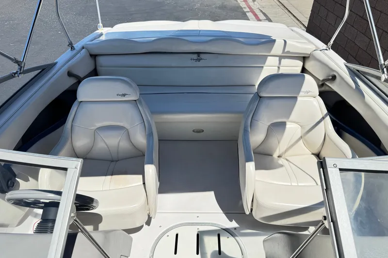 Slide: The Image of Interior of 2001 Four Winns 180 Horizon boat with white seating and steering wheel. - 11