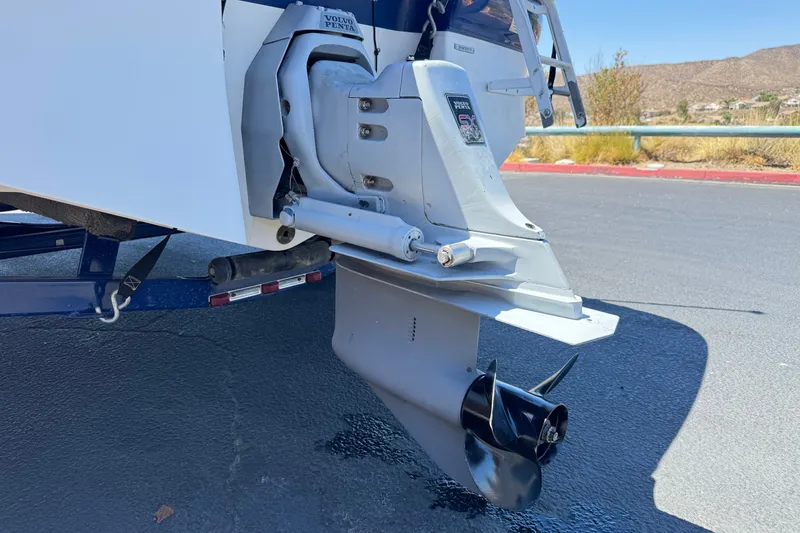 Slide: The Image of 2001 Four Winns 180 Horizon boat with Volvo Penta outdrive, parked on asphalt. - 7