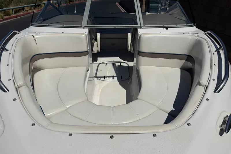 Slide: The Image of 2001 Four Winns 180 Horizon boat interior with white seating and windshield. - 9