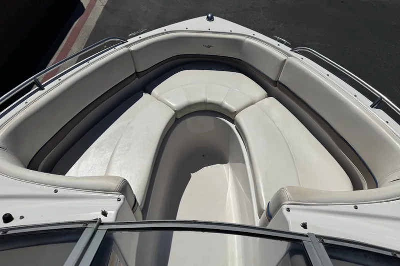 Slide: The Image of 2001 Four Winns 180 Horizon boat interior with white cushioned seating. - 10