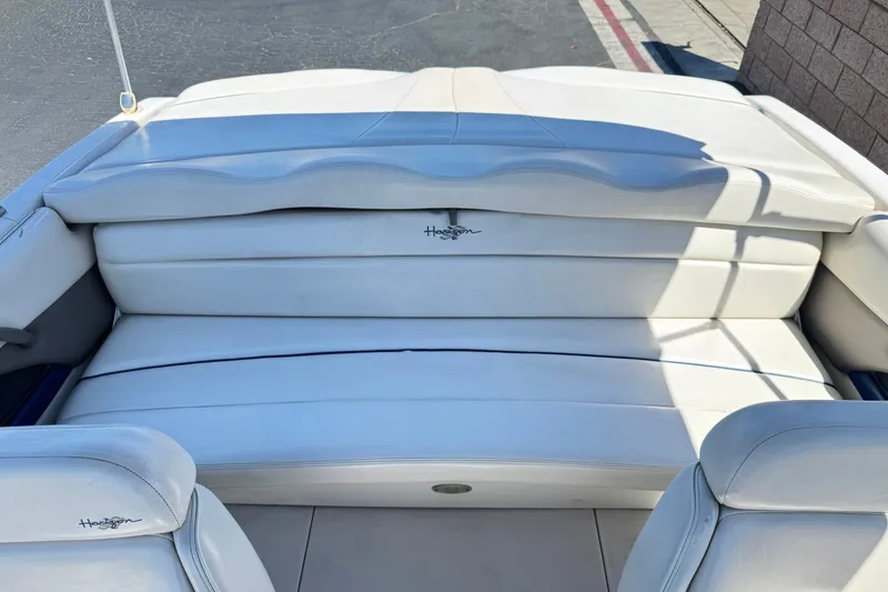 Slide: The Image of 2001 Four Winns 180 Horizon boat interior with white cushioned seating. - 12