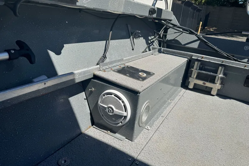 Slide: The Image of Interior of a 2000 North River 18 Mariner boat, featuring a speaker and storage compartment. - 15
