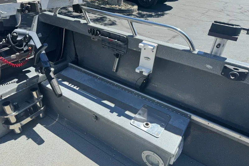 Slide: The Image of Interior of a 2000 North River 18 Mariner boat, featuring steering controls and storage compartments. - 16