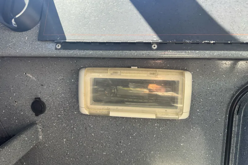 Slide: The Image of Interior view of a 2000 North River 18 Mariner boat dashboard with a covered panel. - 22