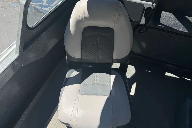 Slide: The Image of Boat interior seat of a 2000 North River 18 Mariner, featuring gray upholstery. - 18