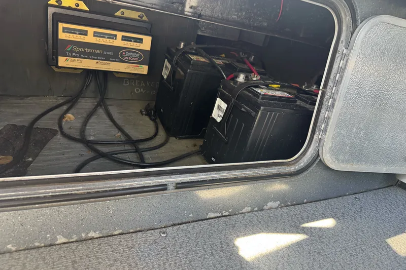 Slide: The Image of Battery compartment of a 2000 North River 18 Mariner with charger and cables. - 20
