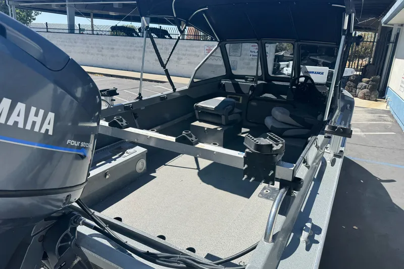 Slide: The Image of 2000 North River 18 Mariner boat with Yamaha engine, spacious interior, and canopy. - 12