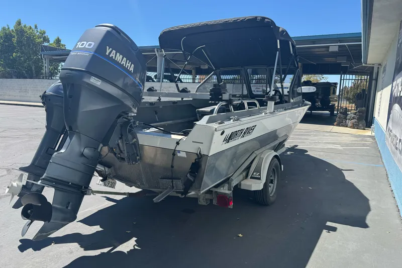 Slide: The Image of North River 18 Mariner boat, 2000 model, with Yamaha 100 outboard motor, parked on trailer. - 9