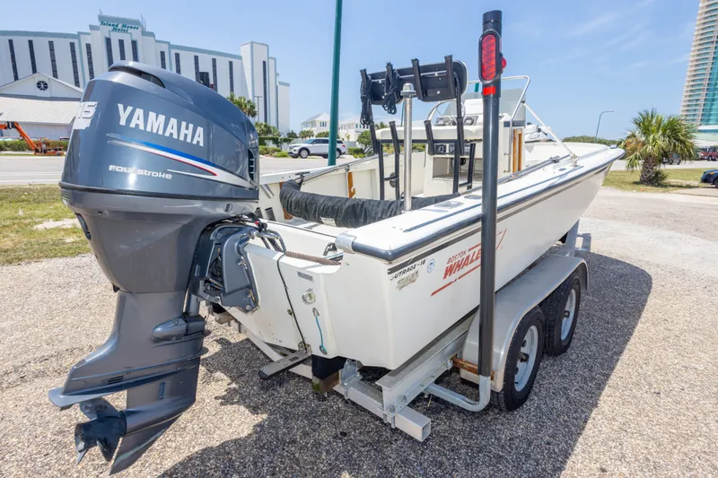 Slide: The Image of 1986 Boston Whaler 18 Outrage boat with Yamaha outboard motor on trailer. - 11