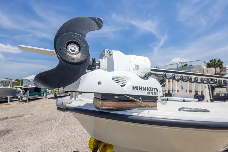 Slide: The Image of 1986 Boston Whaler 18 Outrage with Minn Kota Ulterra trolling motor, parked outdoors. - 16