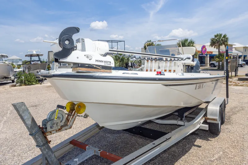 Slide: The Image of 1986 Boston Whaler 18 Outrage boat on trailer with Minn Kota motor, parked outdoors. - 15