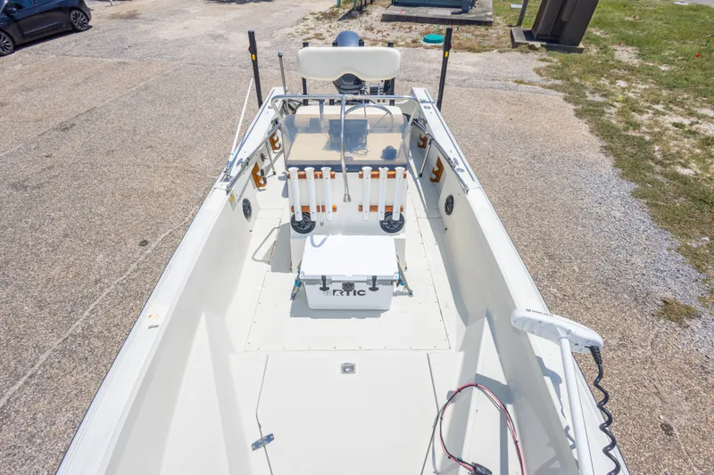 Slide: The Image of 1986 Boston Whaler 18 Outrage boat interior with fishing rod holders and cooler. - 26