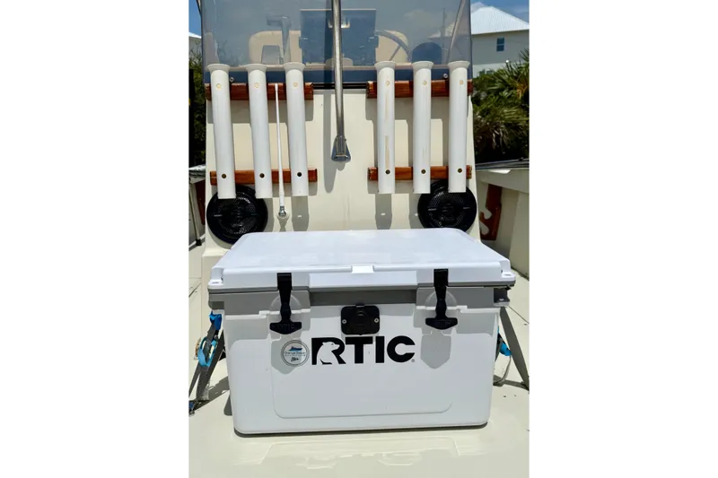 Slide: The Image of White RTIC cooler on 1986 Boston Whaler 18 Outrage boat with rod holders. - 11