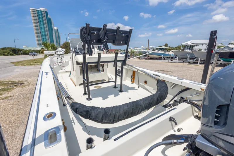 Slide: The Image of 1986 Boston Whaler 18 Outrage boat on display, with modern buildings in the background. - 21