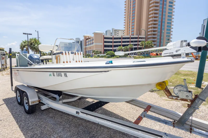 Slide: The Image of 1986 Boston Whaler 18 Outrage boat on trailer, urban background, sunny day. - 9