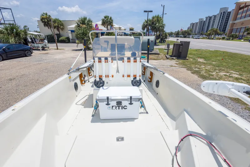 Slide: The Image of 1986 Boston Whaler 18 Outrage boat with RTIC cooler, parked near palm trees and buildings. - 27