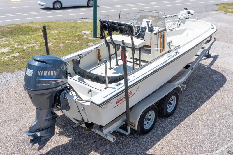 Slide: The Image of 1986 Boston Whaler 18 Outrage boat with Yamaha 115 engine on trailer, parked roadside. - 37