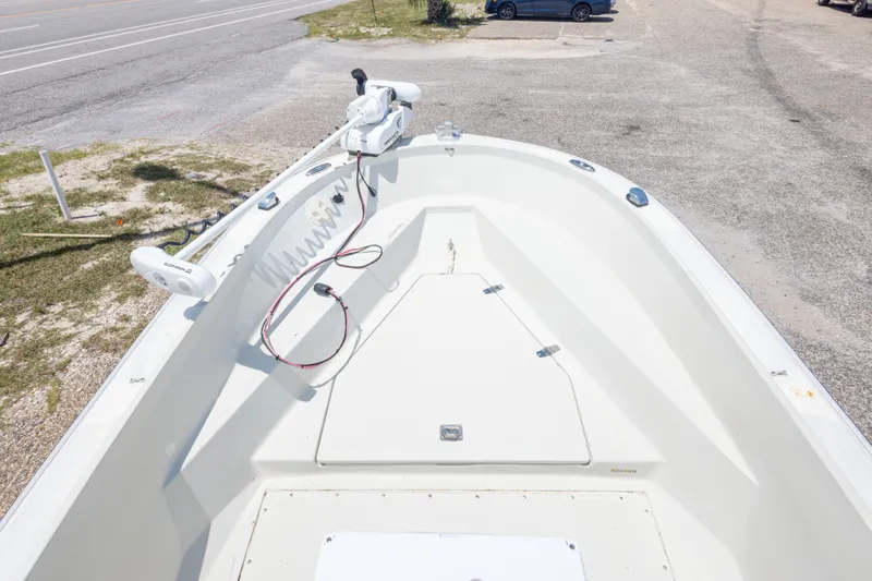 Slide: The Image of 1986 Boston Whaler 18 Outrage boat deck with trolling motor, parked on gravel. - 29