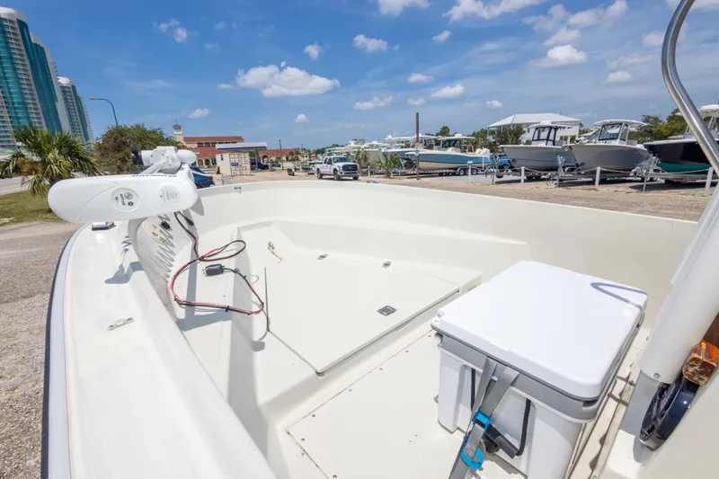 Slide: The Image of 1986 Boston Whaler 18 Outrage boat on display in a sunny marina setting. - 20
