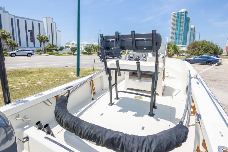 Slide: The Image of 1986 Boston Whaler 18 Outrage boat interior with cityscape background. - 18