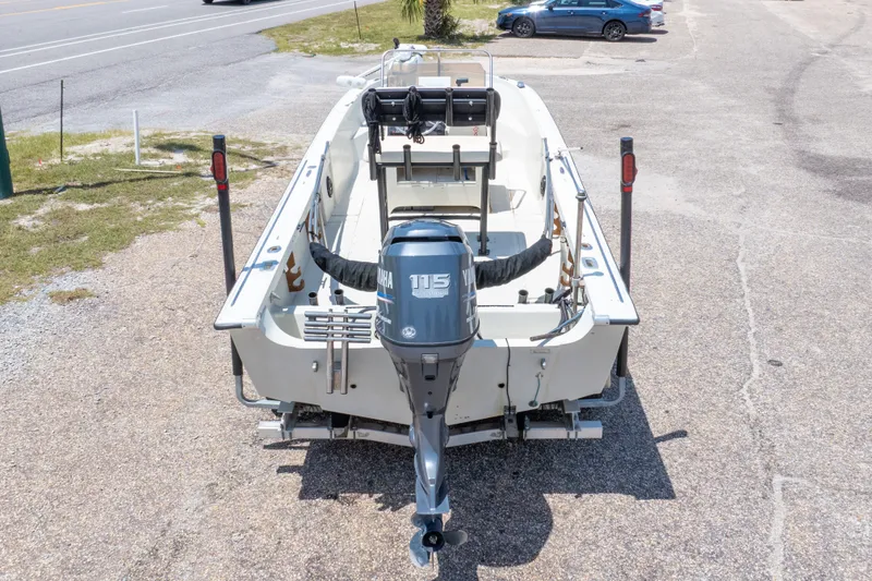 Slide: The Image of 1986 Boston Whaler 18 Outrage boat with Yamaha 115 outboard motor, parked on pavement. - 38