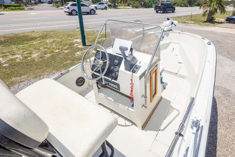 Slide: The Image of 1986 Boston Whaler 18 Outrage boat interior with steering console and seating. - 22