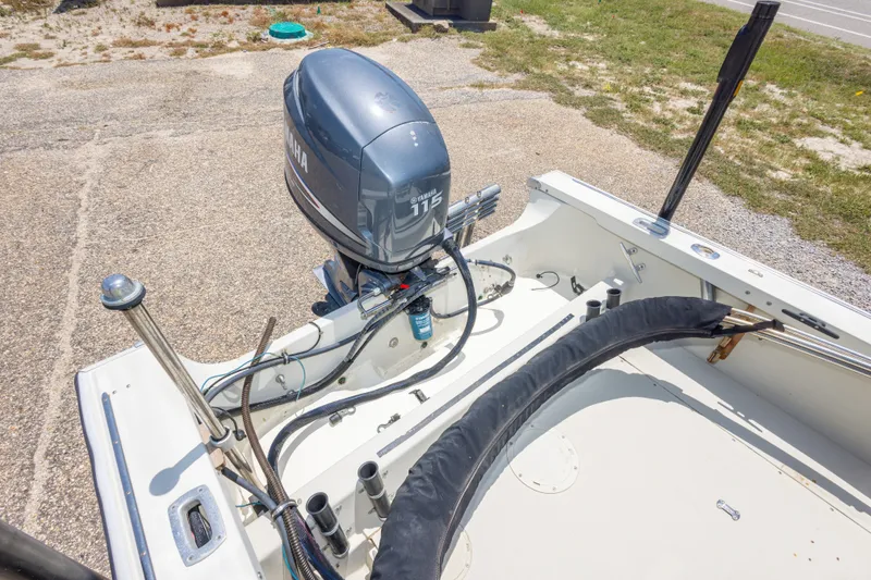 Slide: The Image of 1986 Boston Whaler 18 Outrage with Yamaha 115 outboard motor, parked on concrete. - 23