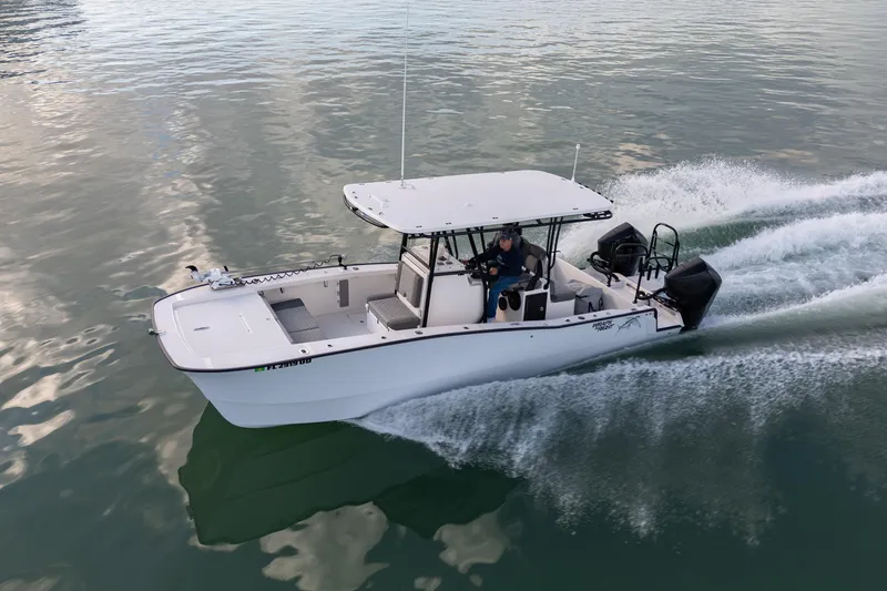 Slide: The Image of A 2026 Calcutta 263 boat cruising on calm waters, showcasing its sleek design and powerful engines. - 2
