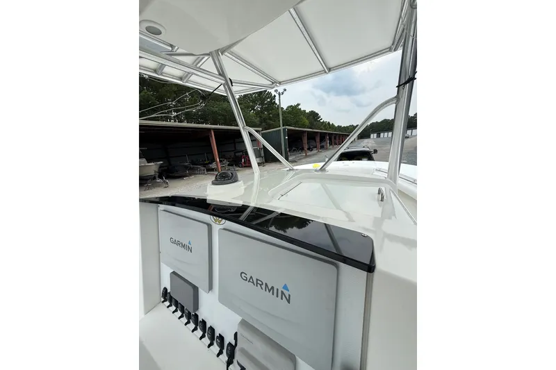 Slide: The Image of 2006 Southport 26 Center Console boat with Garmin electronics, docked outdoors. - 28