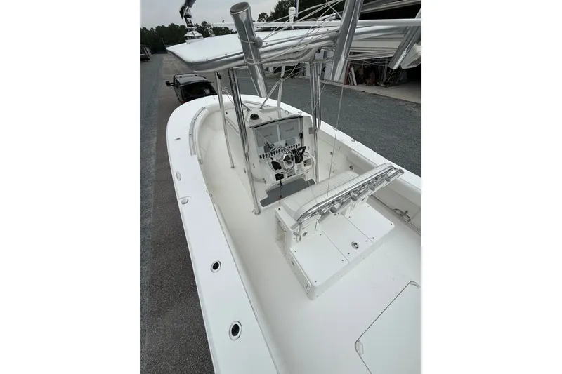 Slide: The Image of 2006 Southport 26 Center Console boat with sleek white deck and modern controls. - 37