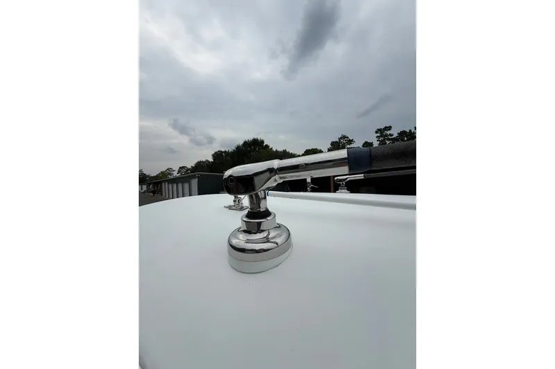 Slide: The Image of Close-up of a 2006 Southport 26 Center Console boat's chrome fitting under cloudy skies. - 38