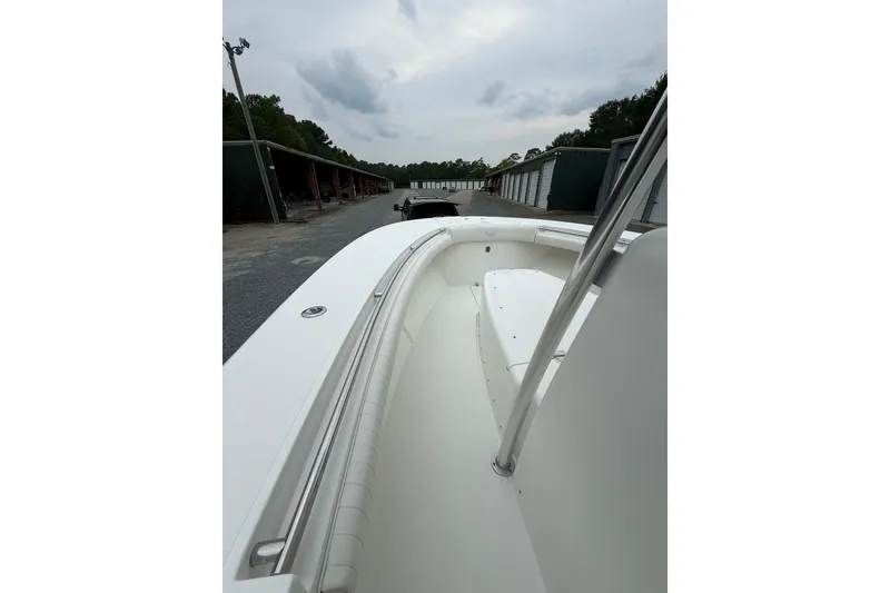 Slide: The Image of 2006 Southport 26 Center Console boat in storage, showcasing sleek white interior design. - 22