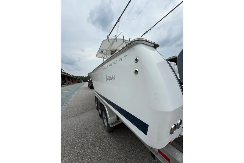 Slide: The Image of 2006 Southport 26 Center Console boat on trailer, side view under cloudy sky. - 4