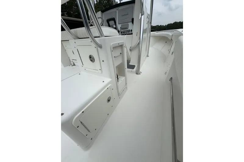 Slide: The Image of 2006 Southport 26 Center Console boat interior with storage compartments and railing. - 15