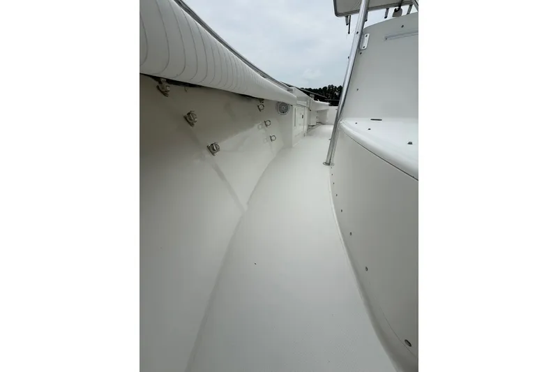 Slide: The Image of 2006 Southport 26 Center Console boat deck, featuring sleek white design and sturdy railings. - 25