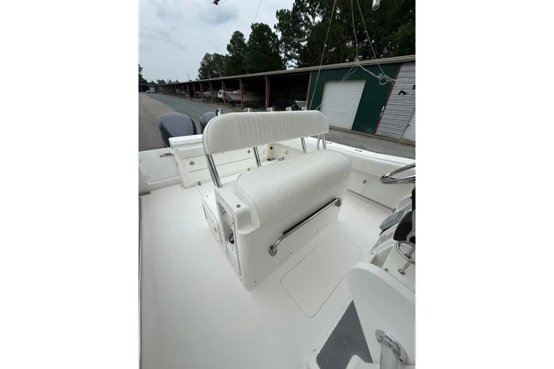 Slide: The Image of 2006 Southport 26 Center Console boat interior with white seating and storage compartments. - 17