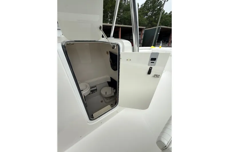 Slide: The Image of 2006 Southport 26 Center Console boat with open cabin door revealing interior space. - 31