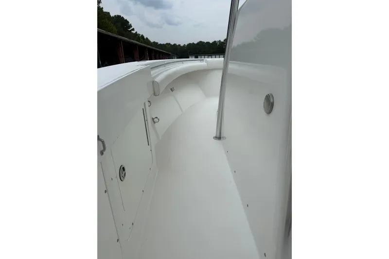 Slide: The Image of 2006 Southport 26 Center Console boat interior with sleek white design and railing. - 20