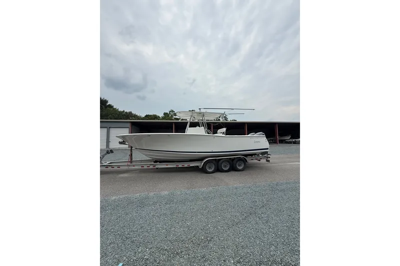 Slide: The Image of 2006 Southport 26 Center Console boat on a trailer, parked outdoors. - 3
