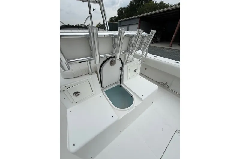 Slide: The Image of 2006 Southport 26 Center Console boat interior with rod holders and storage compartment. - 14