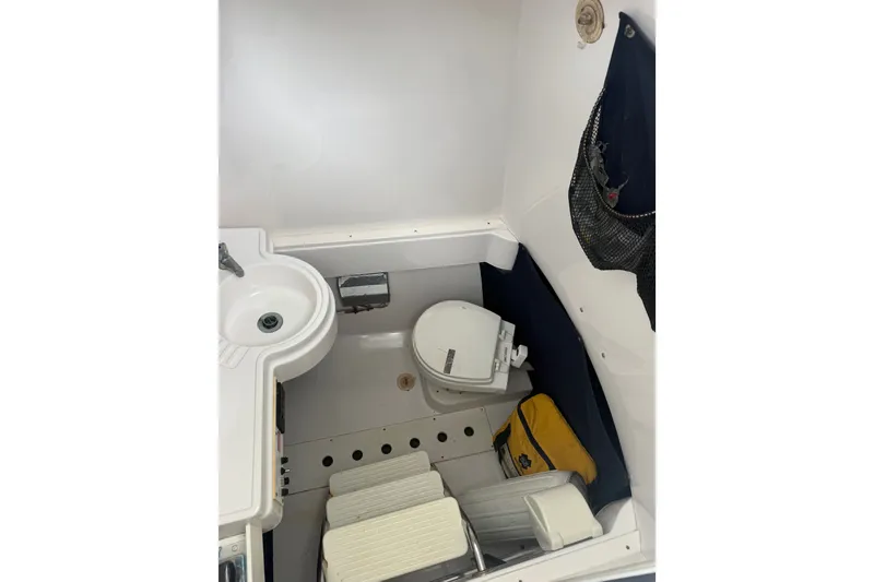 Slide: The Image of 2006 Southport 26 Center Console boat interior with sink and toilet. - 32