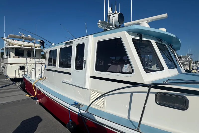 Slide: The Image of 2016 Young Brothers Downeast boat docked at marina under clear blue sky. - 5