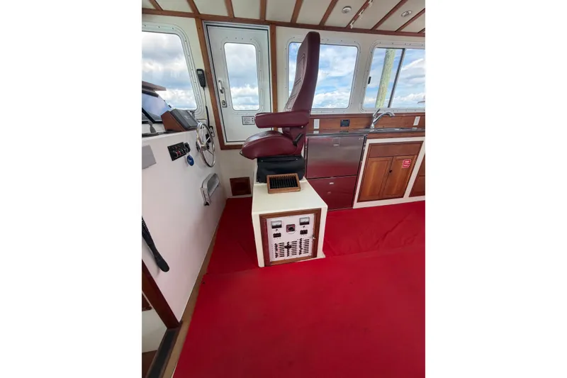 Slide: The Image of Interior of 2016 Young Brothers Downeast boat with captain's chair and control panel. - 22